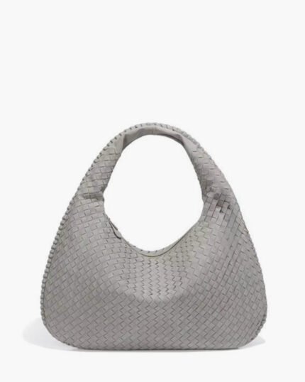 Light grey suede woven texture shoulder bag with single handle, soft eco-friendly material, and spacious modern design.